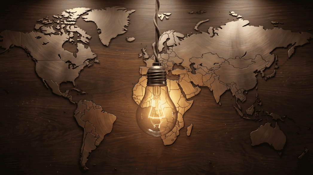 Una lampadina accesa sospesa davanti a un planisfero in legno e metallo, simbolo di innovazione energetica globale